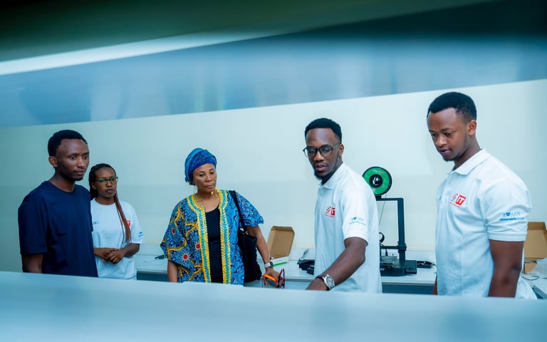Five people in professional setting with medical equipment, wearing casual and medical attire in a modern room