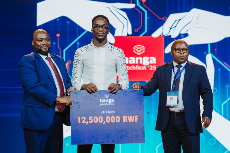 Three men in business attire holding a large check for 12,500,000 RWF at a tech conference event on stage
